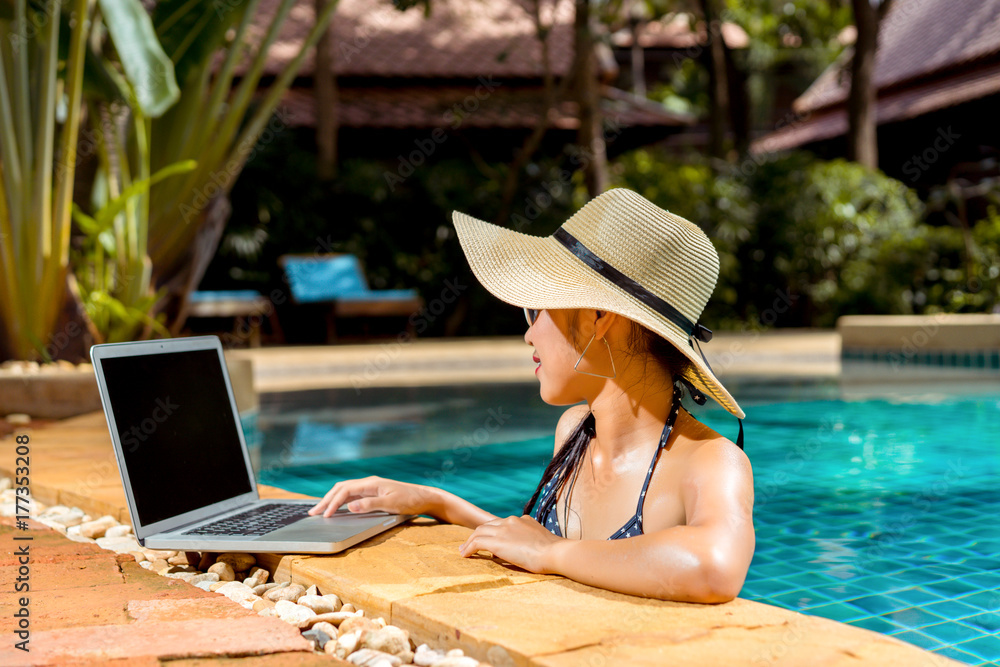 Woman bikini using laptop computer blank screen at swimming pool in resort  edge relaxing hoildays Stock-Foto | Adobe Stock