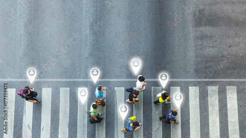 concept art of person icon with world social network connecting of one man walk converse,  the busy city crowd move to pedestrian crosswalk on businees traffric road (Aerial photo, top view) photo