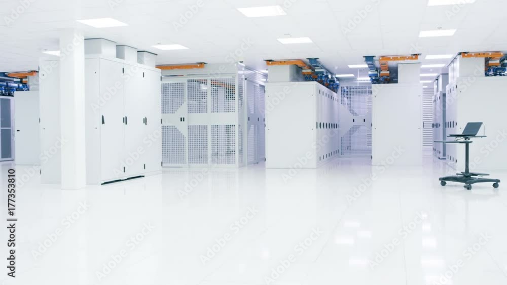 Empty interior of large modern data centre with rows of server racks. Empty interior of large modern data centre with rows of server racks.