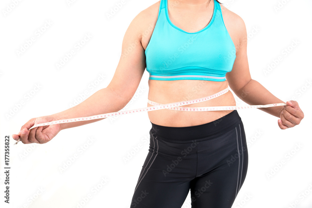 chubby woman measuring her waistline chubby woman measuring her waistline