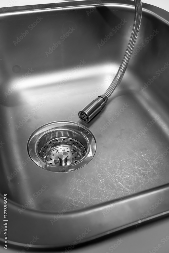 Kitchen faucet with spray hose pulled down to stainless sink Kitchen faucet with spray hose pulled down to stainless sink