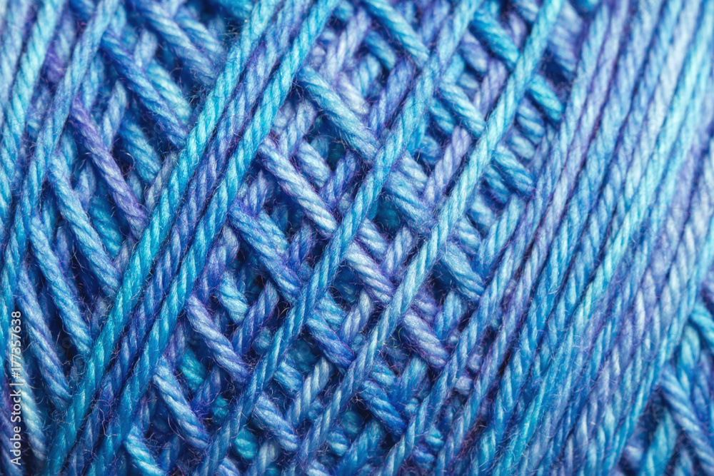 Macro of variegated blue spool of yarn Macro of variegated blue spool of yarn
