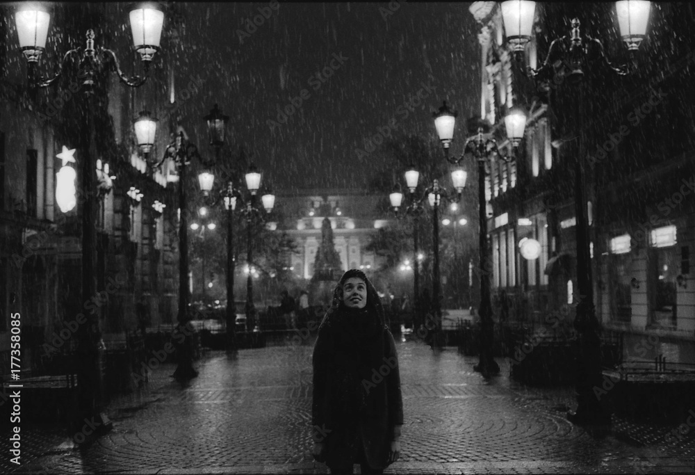 Girl looking to the snow in Saint Petersburg's night Girl looking to the snow in Saint Petersburg's night
