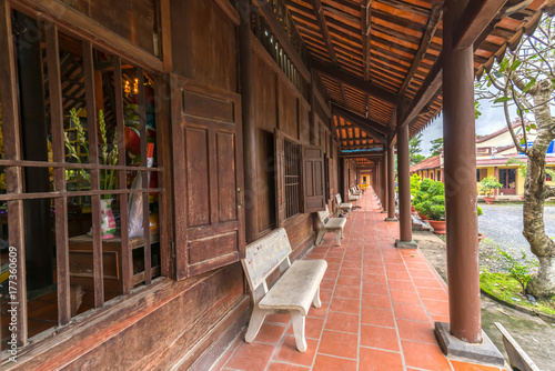 Long An, Vietnam - October 15th, 2017: Architecture monastery gate with door structure classified, large wooden poles create a cool atmosphere, bar the net to develop the mind in Long An, Vietnam