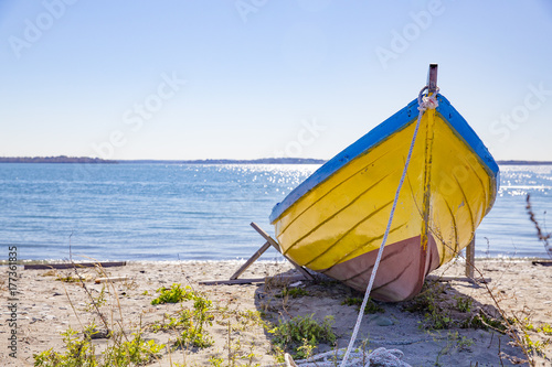 fishing boat on the beach on a sunny day. wooden boat on the sea coast. copy space for your text
