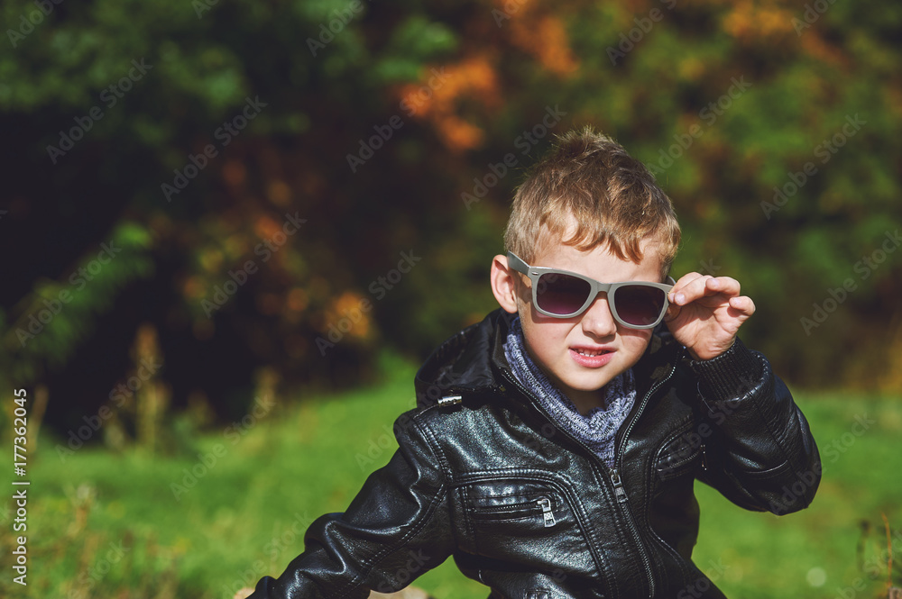 Portrait of boy in autumn Park on a Sunny day , a little boy model posing photographer Portrait of boy in autumn Park on a Sunny day , a little boy model posing photographer