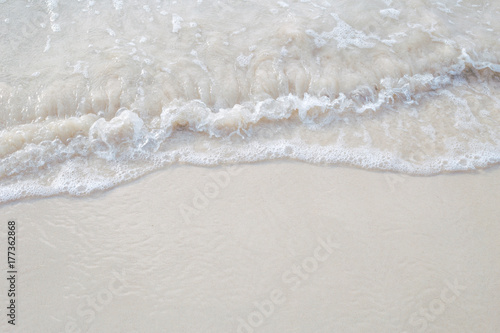 The movement of the waves on the sand is smooth and fine for background,