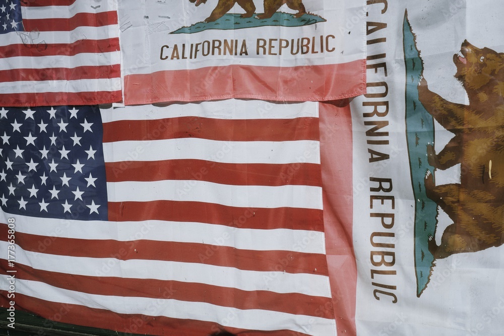 American flags and the flag of California cover a window American flags and the flag of California cover a window