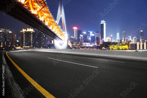 empty asphalt road with modern bridge and modern city © zhu difeng