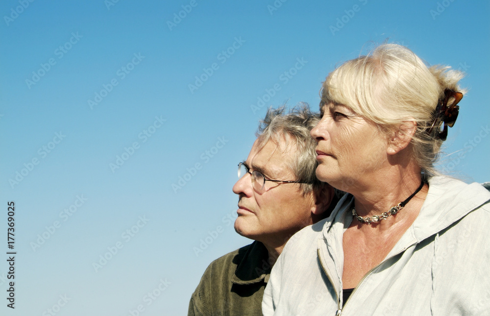 Cute senior Couple looking up against Clear Blue Sky Cute senior Couple looking up against Clear Blue Sky
