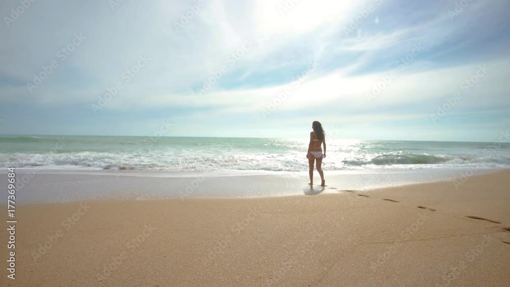 Beautiful woman alone in an amazing and unspoiled beach in the spain coast Beautiful woman alone in an amazing and unspoiled beach in the spain coast