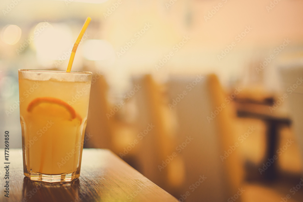 glass of juice and a slice of Orange and straw glass of juice and a slice of Orange and straw