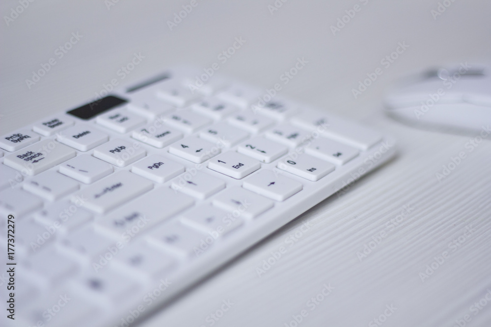 white computer mouse and keyboard on a white table, business concept white computer mouse and keyboard on a white table, business concept