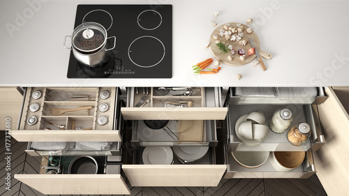 Tableau sur toile Opened wooden kitchen drawer with accessories inside, solution for kitchen stora