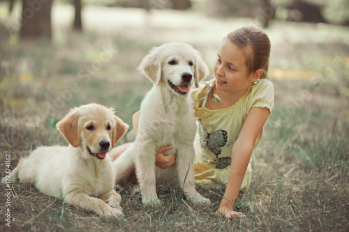 Retriever pup Lovely scene cute young teen girl enjoying posing summer time vacation with best friend dog ivory white labrador puppy.Happy airily careless childhood life world of dreams with puppies photo