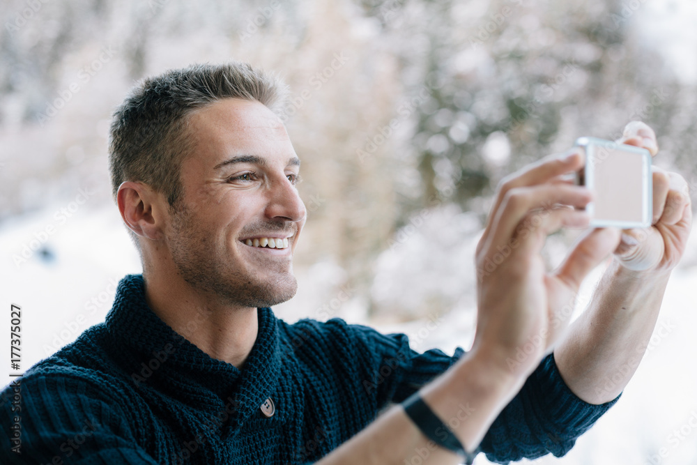 Young man taking a photo with your smartphone Young man taking a photo with your smartphone