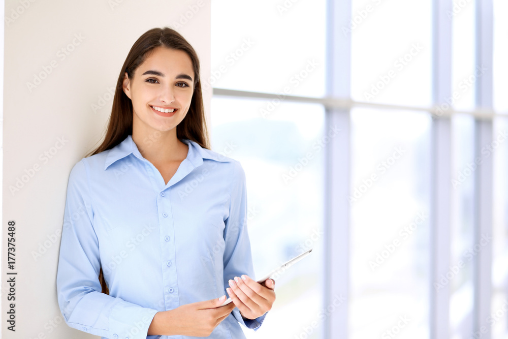 Young brunette businesswoman or student girl looking at camera