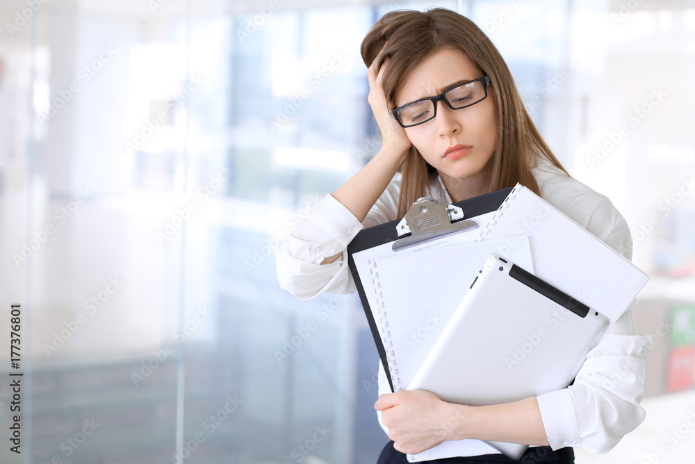 Tired business woman while standing in the office Tired business woman while standing in the office