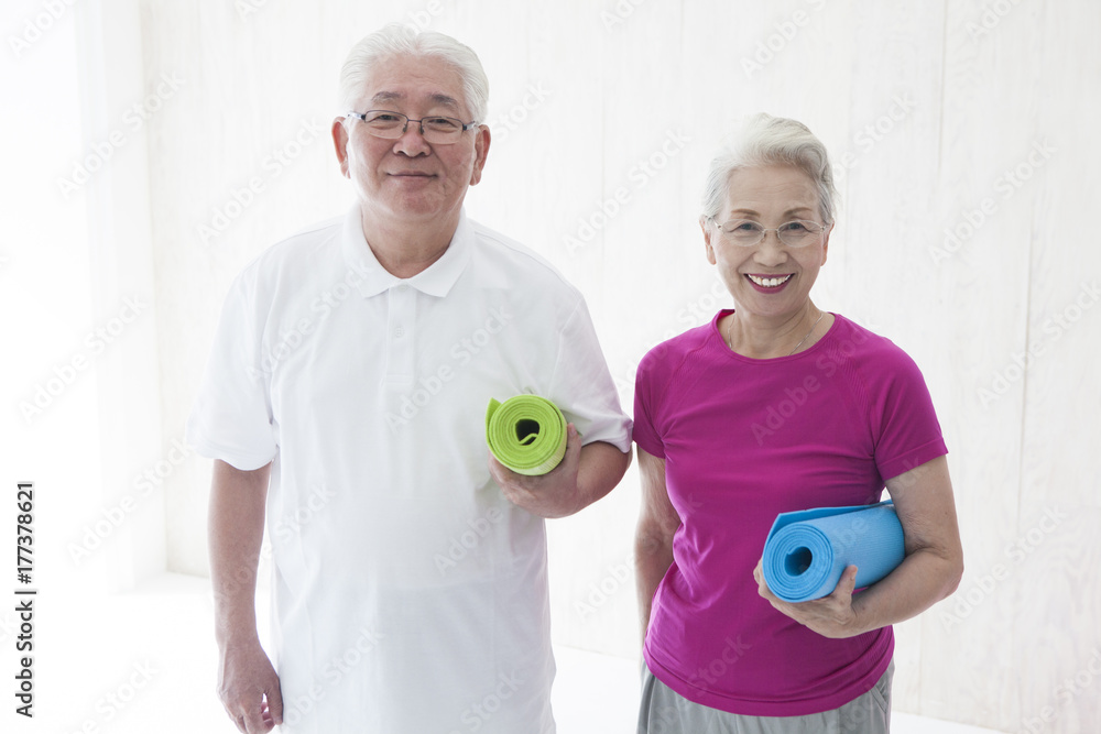 An old couple is exercising together An old couple is exercising together