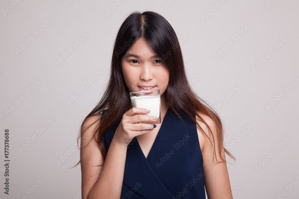 Healthy Asian woman drinking a glass of milk. Healthy Asian woman drinking a glass of milk.