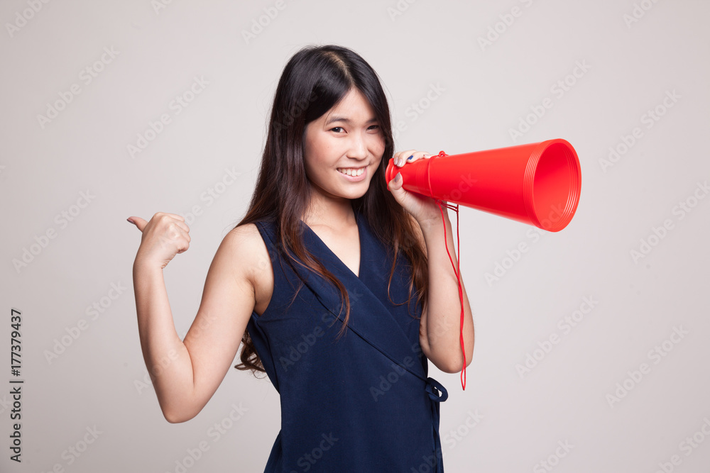 Beautiful young Asian woman show thumbs up announce with megaphone.