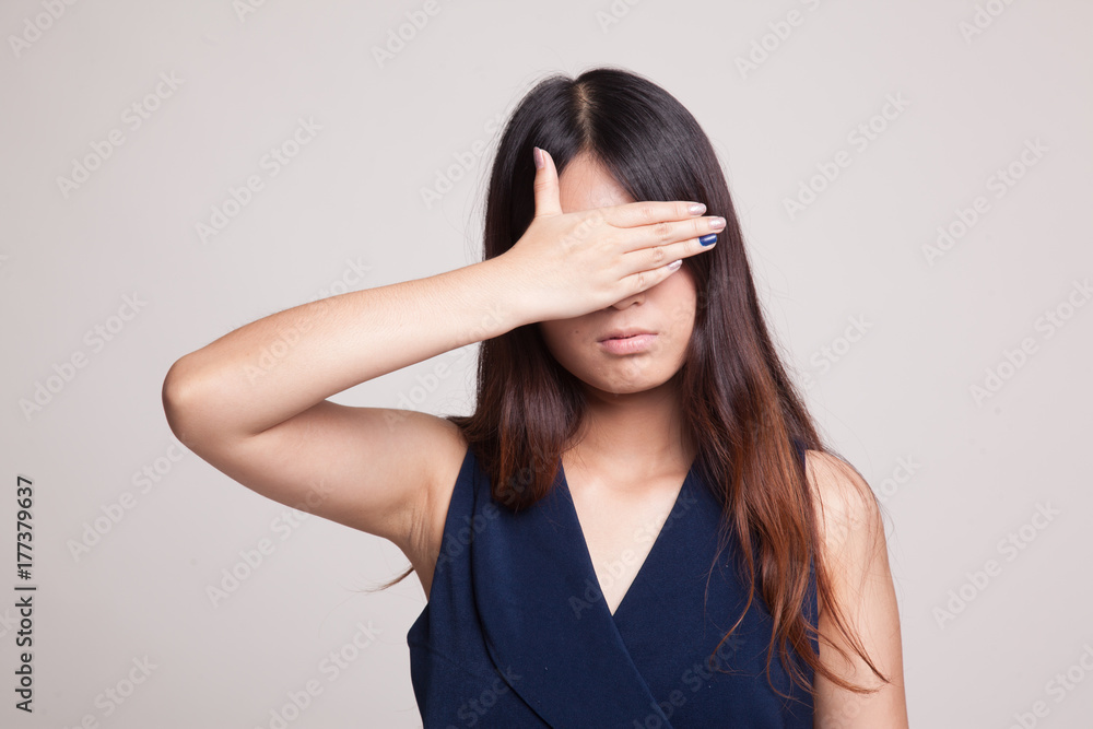 Young Asian woman close her eyes with hand. Young Asian woman close her eyes with hand.