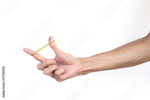 A man hand holding elastic rubber band on white background. Rubber band used to tie the goods. Or used to close the plastic bag. Unfold rubber band by human hand.