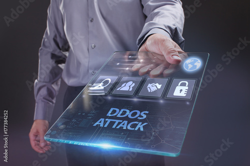 The concept of business, technology, the Internet and the network. A young entrepreneur working on a virtual screen of the future and sees the inscription: Ddos attack
