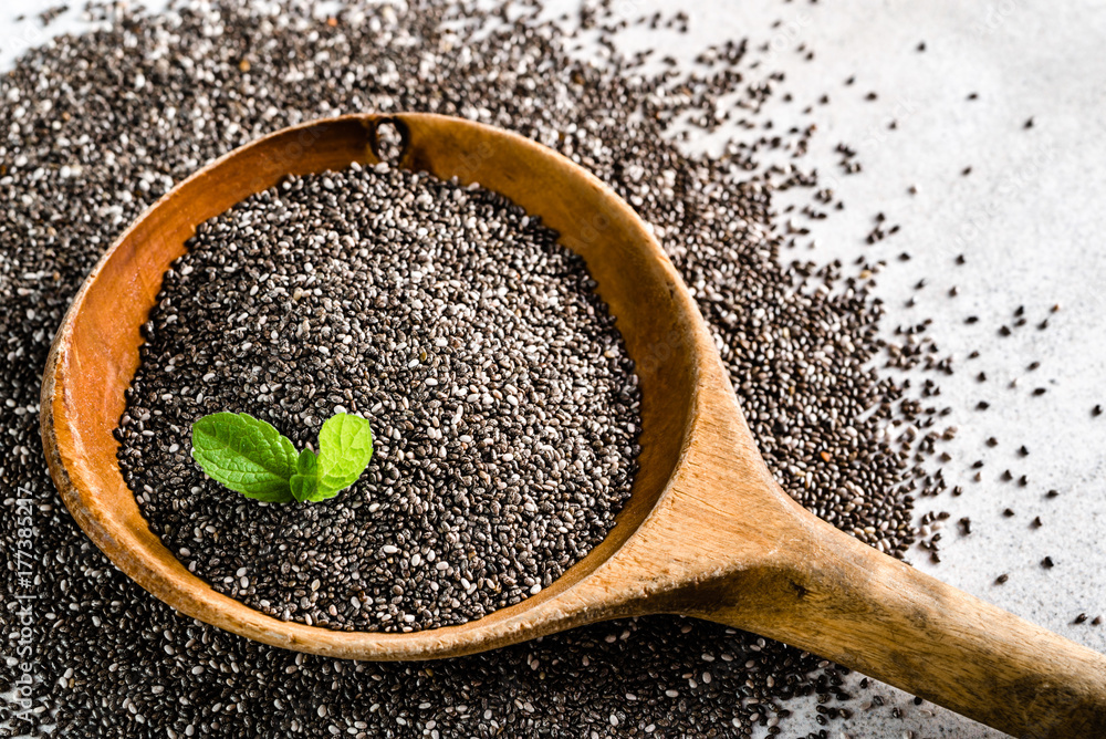 Healthy food, source omega3 chia seed, closeup on wooden spoon