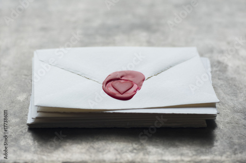 Stack of letters with heart shaped wax seal