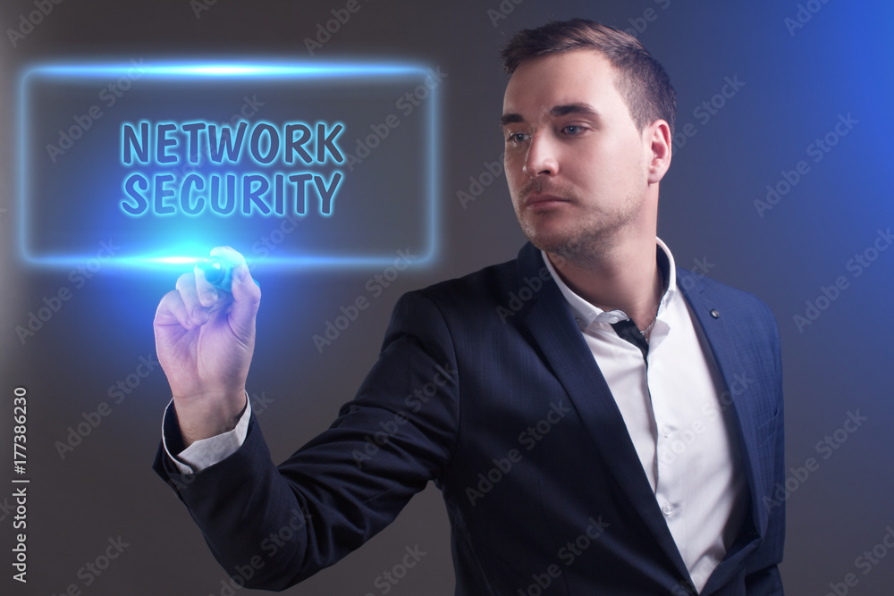 The concept of business, technology, the Internet and the network. Young businessman showing inscription: Network security The concept of business, technology, the Internet and the network. Young businessman showing inscription: Network security