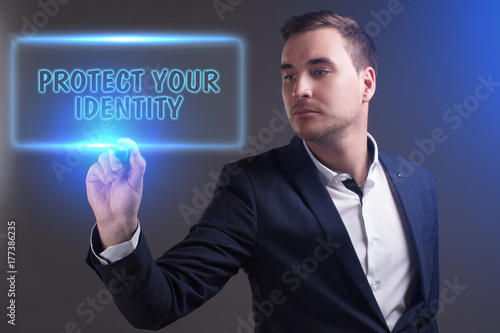 The concept of business, technology, the Internet and the network. Young businessman showing inscription: Protect your identity
