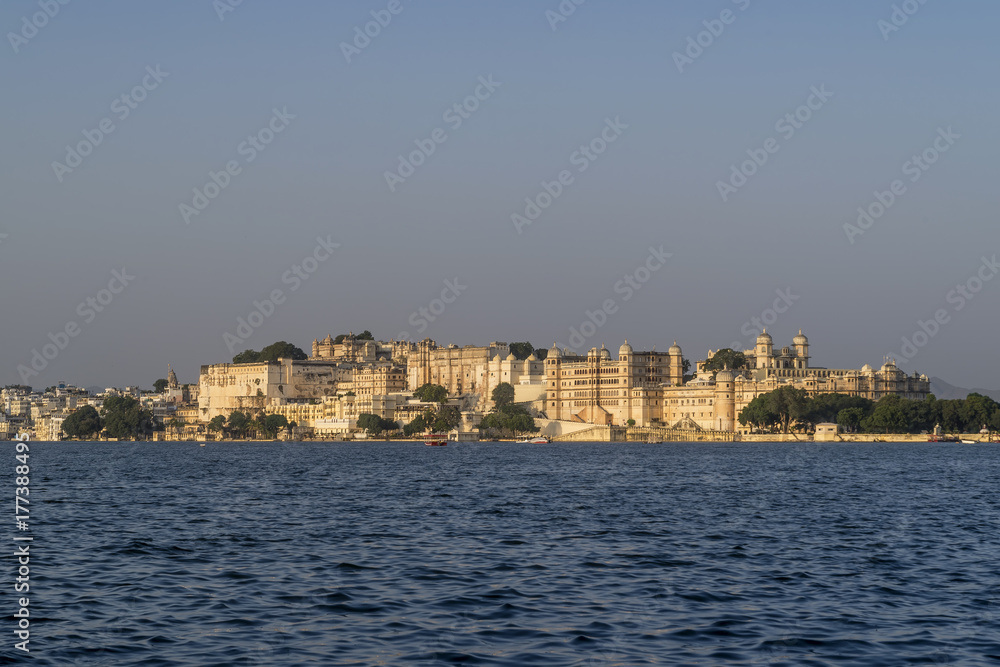 Stunning panoramic view of the ancient City Palace complex in Udaipur, India, from Lake Pichola
