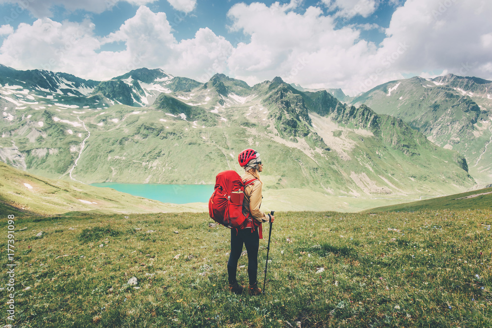 Woman hiking in mountains Travel Lifestyle adventure concept happy emotions summer vacations outdoor exploring wild nature