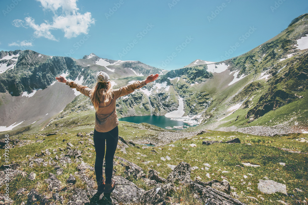 Woman hands raised enjoying landscape mountains and lake Travel Lifestyle adventure concept summer vacations outdoor exploring wild nature