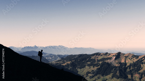 silhouette of a hiker in the alps