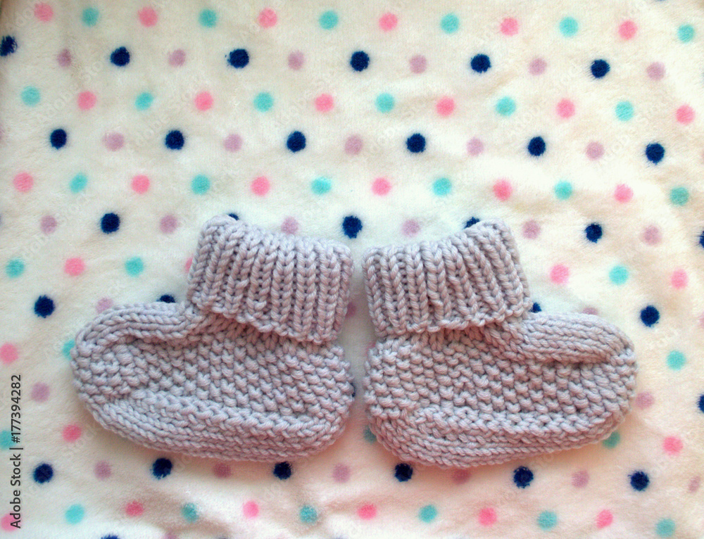 Waiting baby. woolen socks - the first shoes for a newborn baby on a white  background in polka dots. the best gift for birth. Stock Photo | Adobe Stock