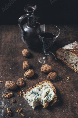 Slice of bread with blue cheese, wine and wallnuts photo