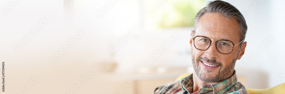 Mature man with eyeglasses relaxing at home- template - obrazy, fototapety, plakaty 