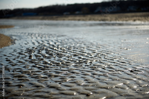 Waves covered rippled sand on a beach