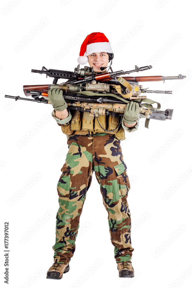 soldier with rifle wearing Santa claus cup and holding cardbox isolated on white background