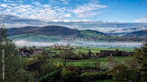 Misty morning view across beuatiful valley