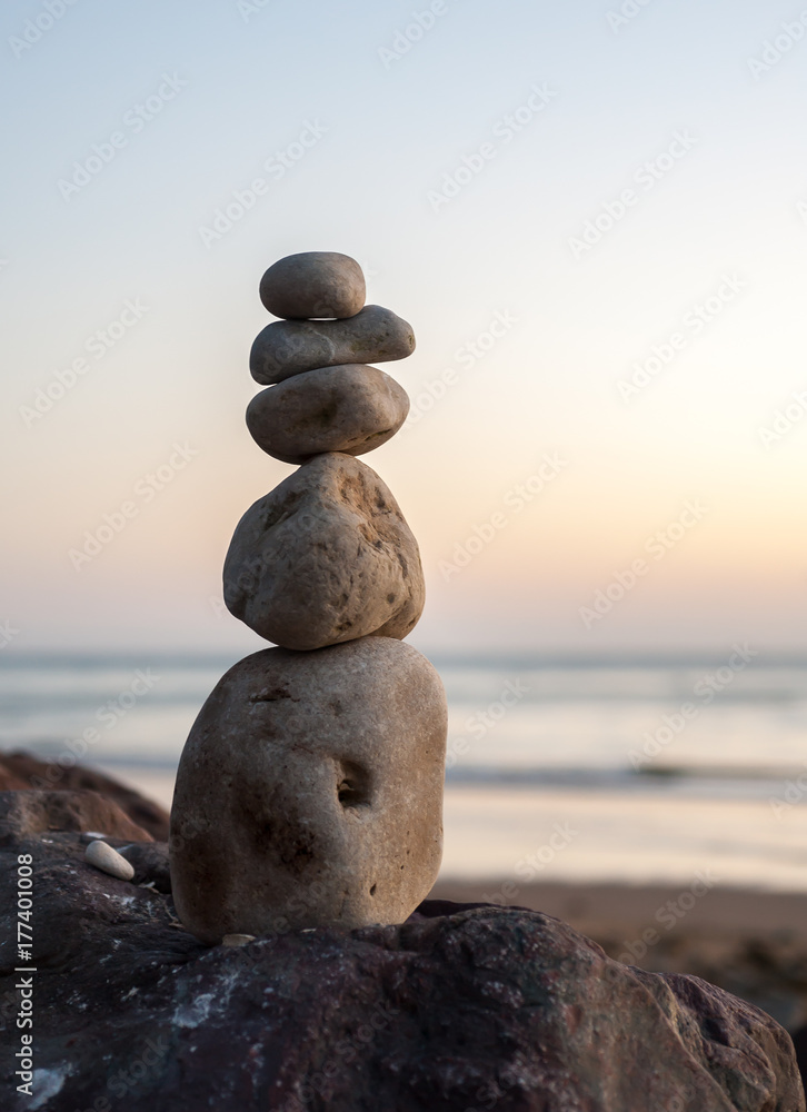 A pile of stacked pebbles on the beach A pile of stacked pebbles on the beach