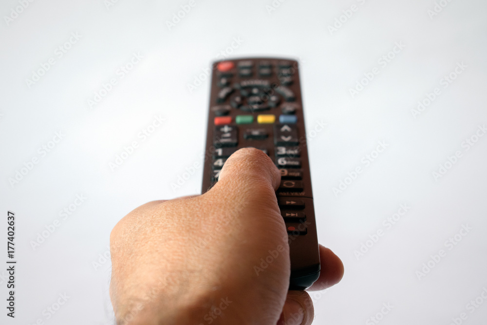 hand with tv remote control isolated on white background hand with tv remote control isolated on white background
