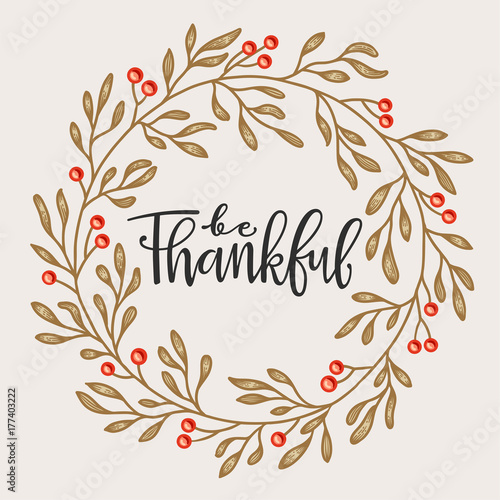 Thanksgiving greeting card with frame of leaves and berries.
