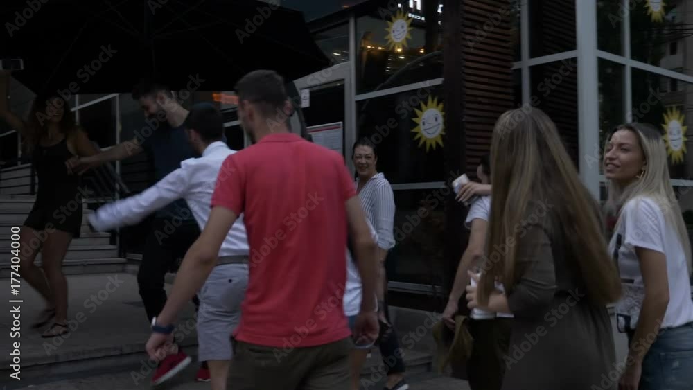 Group of happy friends meeting in front of the club and enter the party hanging out together having fun Group of happy friends meeting in front of the club and enter the party hanging out together having fun