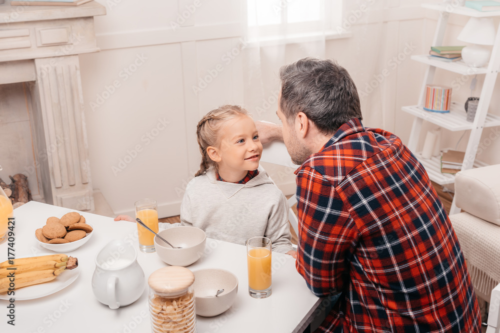 father and daughter having breakfast father and daughter having breakfast
