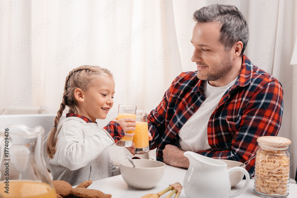 father and daughter having breakfast father and daughter having breakfast