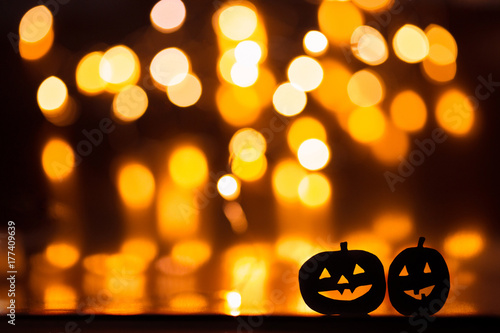Halloween Pumpkins on the background of orange lights bokeh