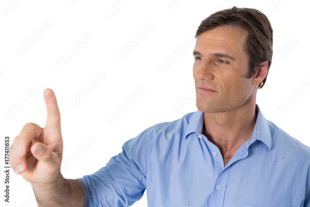 Male executive pressing an invisible virtual screen Male executive pressing an invisible virtual screen